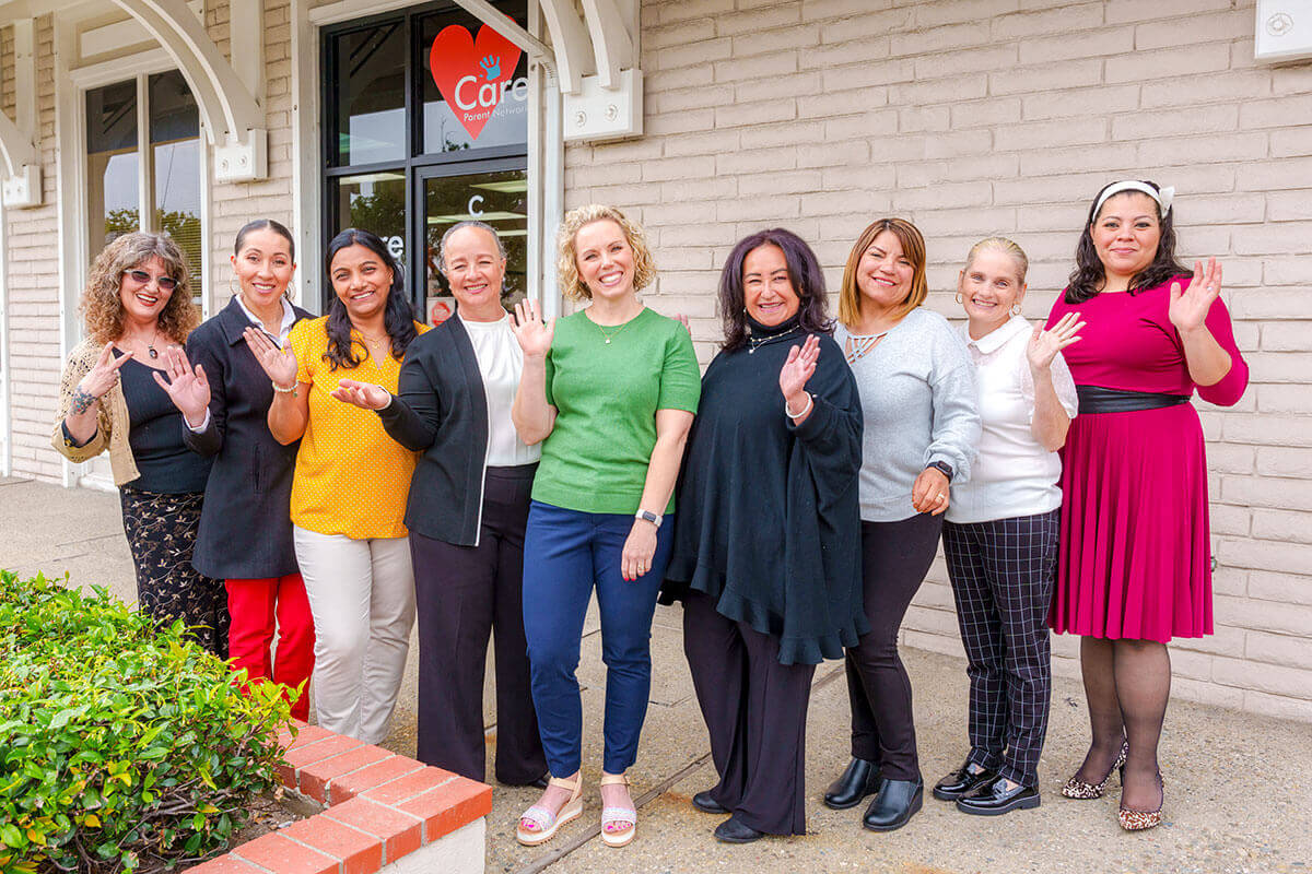 Friendly staff surrounds a student with disabilities