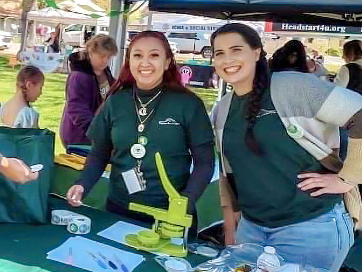 Friendly staff greet visitors at an outdoor event