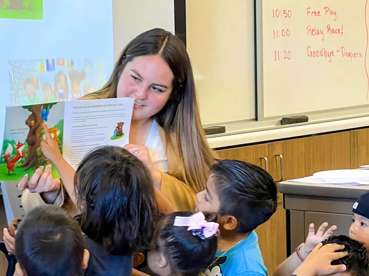 A teacher reads a group of students a storybook